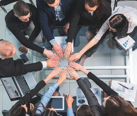 Wall Mural - top view. business team joining their hands in a circle