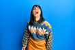 © Krakenimages.com - Young hispanic woman wearing casual winter sweater winking looking at the camera with sexy expression, cheerful and happy face.