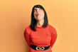 © Krakenimages.com - Young hispanic woman wearing casual clothes making fish face with lips, crazy and comical gesture. funny expression.