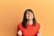 © Krakenimages.com - Young hispanic woman wearing casual clothes very happy and excited doing winner gesture with arms raised, smiling and screaming for success. celebration concept.