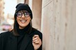© Krakenimages.com - Young hispanic woman smiling happy standing at the city.