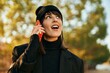 © Krakenimages.com - Young hispanic woman smiling happy talking on the smartphone at the park.