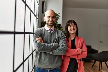 Sticker - Two hispanic business workers smiling happy with arms crossed gesture standing at the office.