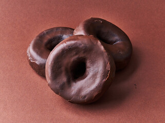  Bunch of chocolate doughnuts on a brown background