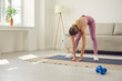 © Studio Romantic - Young woman in sportswear train exercise on mat at home on lockdown or quarantine. Sporty fit millennial girl do morning gymnastics, have workout fitness session indoors. Healthy lifestyle concept.