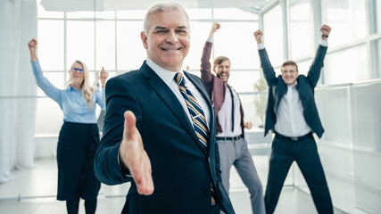 Poster - confident businessman holding out his hand for a handshake.