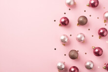 Top View Photo Of Pink Christmas Tree Decorations Balls And Shiny Confetti On Isolated Pastel Pink Background With Blank Space