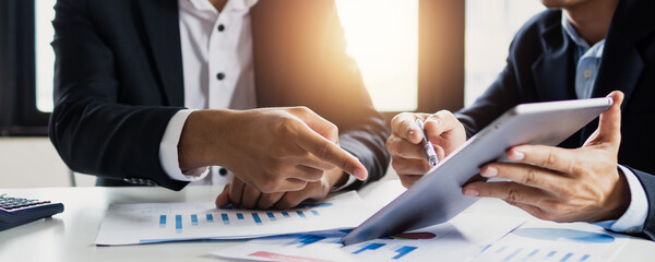 legal and businessman advisor, two business people talking, planning analyze investment and marketing on tablet in office.