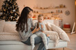 © dtatiana - Happy family mother and child daughter near Christmas tree at home