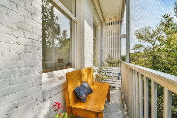 Cozy nice balcony with a yellow bench