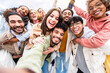 © Davide Angelini - Multiracial friends group taking selfie portrait outside - Happy multi cultural people smiling at camera - Human resources, college students, friendship and community concept