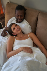 Wall Mural - Tranquil woman and smiling man resting in bedroom