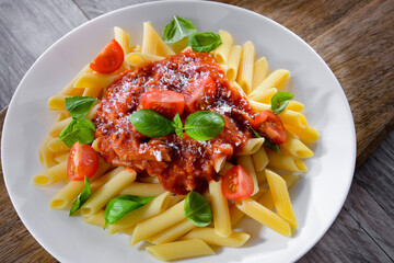 Composition with a plate of pasta penne rigate