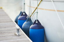 White Fenders Suspended Between A Boat And Dockside For Protection. Maritime Fenders