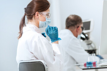 Wall Mural - close up. female scientist sitting at a laboratory table.