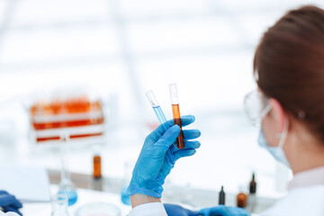 Poster - rear view . test tube in hands of the laboratory employee.