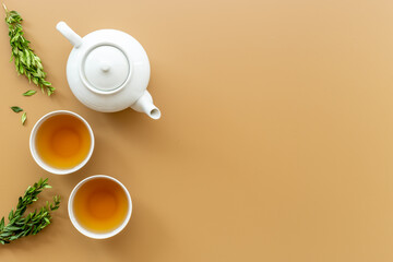 Asian tea set with white teapot and two cups, top view