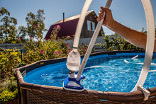 Cleaning The Pool With A Vacuum Cleaner. Cleaning Equipment For Small Pools