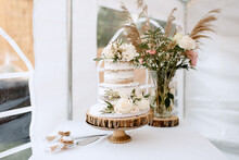 Wedding Cake And Bouquet On Table