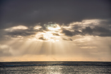 Sticker - Sun rays through the cloudy sky at dusk.