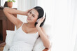 © u photostock - Asia woman sitting on the chair in morning with headphone and smart phone