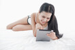 © u photostock - Asia woman lying on the bed in morning with tablet