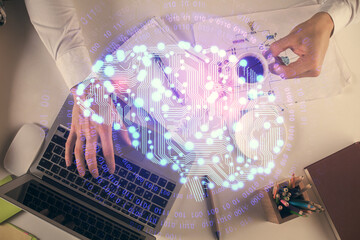 Double exposure of man's hands typing over computer keyboard and brain hologram drawing. Top view. Ai and data technology concept.