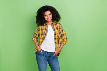 Wall Mural - Photo of cute brunette millennial lady wear yellow shirt jeans isolated on green color background