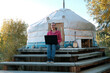 © Светлана Волынкина - Female Freelancer Using Laptop while Sitting on the Steps of the Mongolian Yurt in Autumn Day