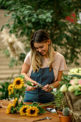 Florist woman making a bouquet of fresh flowers in a flower shop