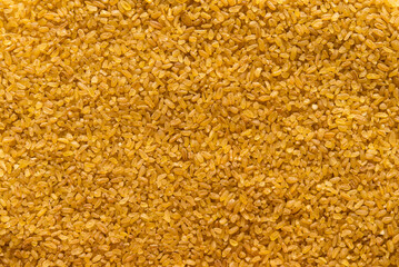 Poster - Bulgur - cooked and dried wheat groats, food background	