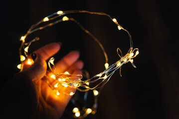 Wall Mural - Christmas background, green pine branches festive background. Creative composition with border and copy space. Christmas decoration with bokeh lights from light bulbs