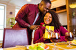 © yurakrasil - african american couple celebrate 14 february valentines day in living room