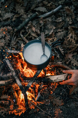 Wall Mural - Boiling milk over the campfire