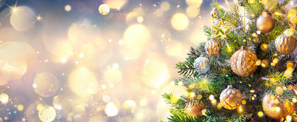 Wall Mural - christmas tree in golden sparkle background - shiny balls with vintage defocused abstract lights