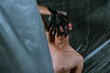 © Denis - Portrait of a young man with unusual makeup. The guy is posing without a T-shirt. Black paint on the face.