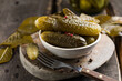 Pickles - canned fermented pickled cucumbers on wooden background. Homemade sour marinated vegetables