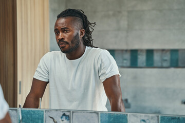 Wall Mural - Concentrated man looking at his face in bathroom