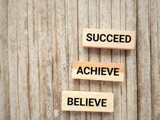 Wall Mural - Inspirational and Motivational Concept - believe achieve succeed text background. Stock photo.