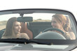 © Antonioguillem - Two happy friends in a convertible car