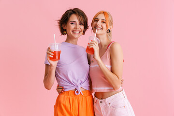 Wall Mural - White lesbian couple laughing and drinking soda while hugging