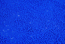 The Texture Of The Surface Of Scattered Blue Beads For Needlework. Beads For Women's Needlework. Blue Round Granules. Textured Effect. Background Image. Template For Text.