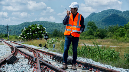 Wall Mural - People or worker standing on railways in hand hold folder check sheet for inspector rail road. Inspector engineer on railways.