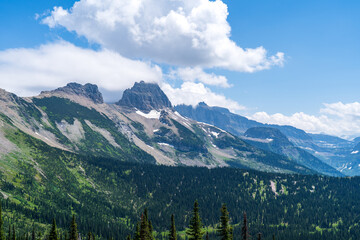 View of the Garden Wall, Grinnell Glacier Overlook, and the Continental Divide while hiking the Highline Trail in Glacier National Park in Montana on a sunny summer day