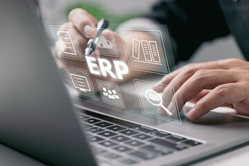 Aufkleber - Enterprise Resource Planning (ERP) is a business resource planning software system. On a virtual screen, there is a concept of a hand typing computer laptop icons.