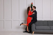 © New Africa - Lovely couple under mistletoe bunch near light grey wall indoors. Space for text