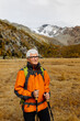 © Westend61 - Smiling senior tourist with hiking poles looking away at Rhaetian Alps, Italy