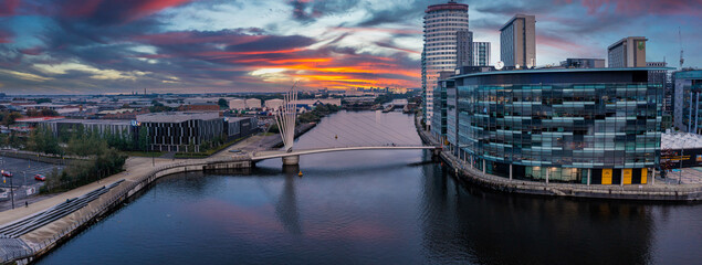 Fototapete - Aerial view of the Media City UK is on the banks of the Manchester Ship Canal in Salford and Trafford, Greater Manchester, England at dusk.