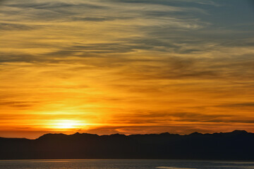 Wall Mural - Beautiful evening sky and sunset on the background of mountains on the horizon