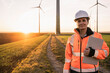 © Westend61 - Smiling engineer with digital tablet at wind park